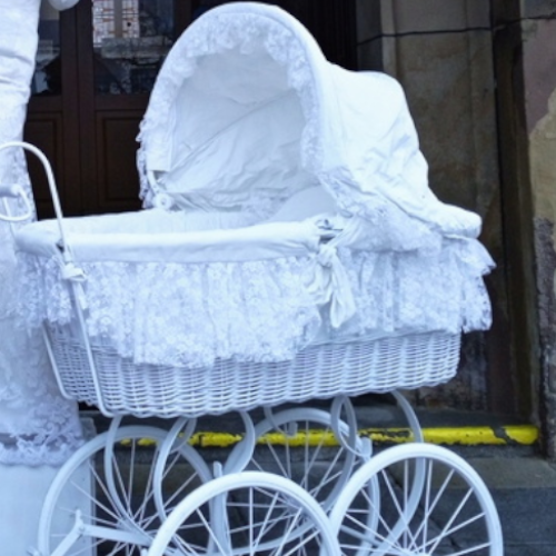 White lady with a historic pram